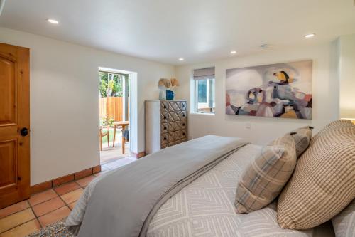 a bedroom with a bed and a painting on the wall at Montecito SeaRenity by Paradise Retreats in Montecito