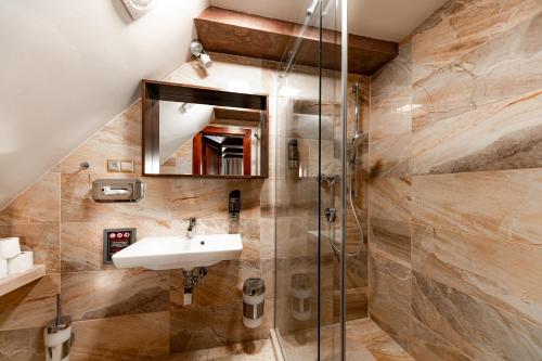 a bathroom with a sink and a shower at Vila Lampášik in Donovaly