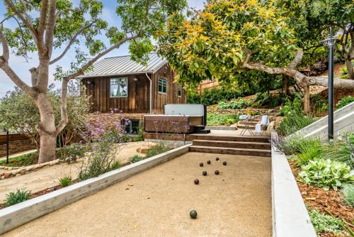 a house with a garden with a game of billiards at Ocean View Loft by Paradise Retreats in Summerland