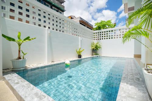 a swimming pool in the middle of a building at Happiness Pool villa Phuket Patong 154 in Patong Beach