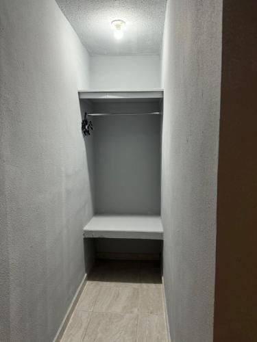 a empty closet with a bench in a room at Estancias Nava #3 in San Antonio