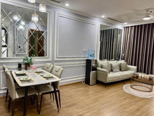 a living room with a table and a couch at Vinhomes Times City - QMP in Hanoi