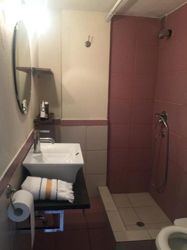 a bathroom with a sink and a shower at AEGEAN view ! in Kavála