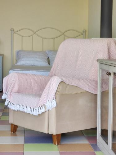 a bedroom with a bed with a pink blanket at AEGEAN view ! in Kavála