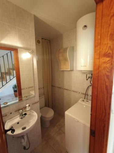 a small bathroom with a toilet and a sink at Between the sky and the sea in Alicante