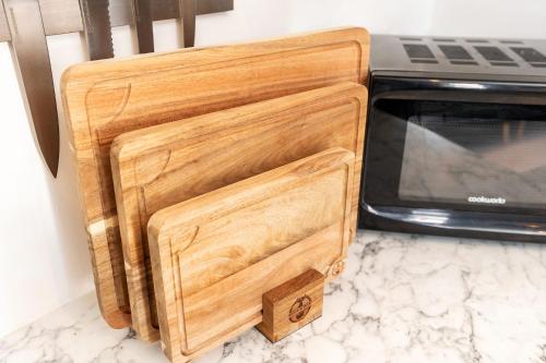 a wooden box sitting next to a microwave at Archies Cozy Retreat A Stylish Derby Hideaway in Derby