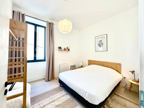 une petite chambre avec un lit et une fenêtre dans l'établissement Nemausus - T2 pour 4 en Centre-Ville, à Nîmes