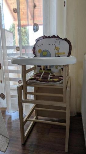 a high chair with a table in front of a window at Dynamic Bike Home in Curtea de Argeş