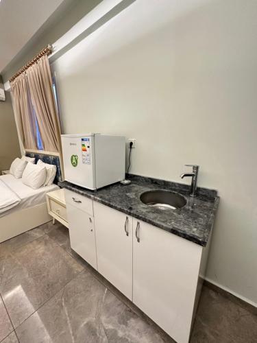 a bathroom with a sink and a bed at Sevil new apart in Istanbul