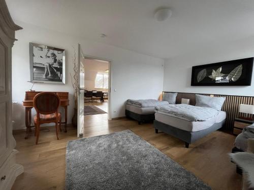 a living room with a bed and a desk at Ferienwohnung Varbrook in Niederkrüchten