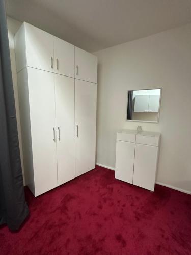 an empty room with white cabinets and a mirror at Sissi Suite in center of Vienna in Vienna
