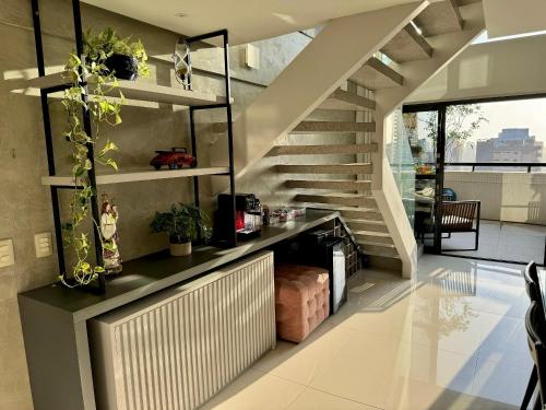 a living room with a staircase in a house at Ed. Connext Loft (ref. Hotel Mercure Boulevard) in Curro Velho