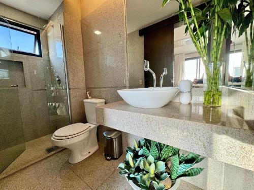 a bathroom with a sink and a toilet and a mirror at Ed. Connext Loft (ref. Hotel Mercure Boulevard) in Curro Velho
