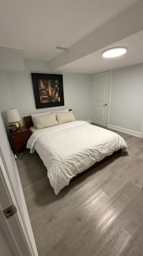 a bedroom with a large white bed in it at Brand new 2 bedroom basement apartment in Ajax