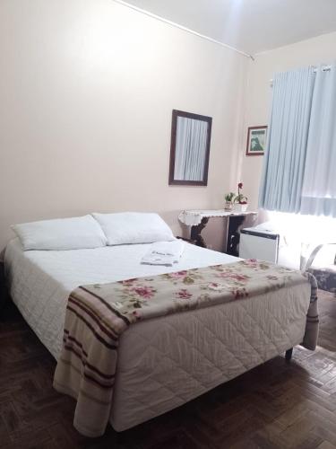 a bedroom with a bed and a table in it at Oceano Hotel in Torres