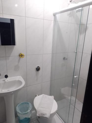 a bathroom with a shower and a toilet and a sink at Oceano Hotel in Torres