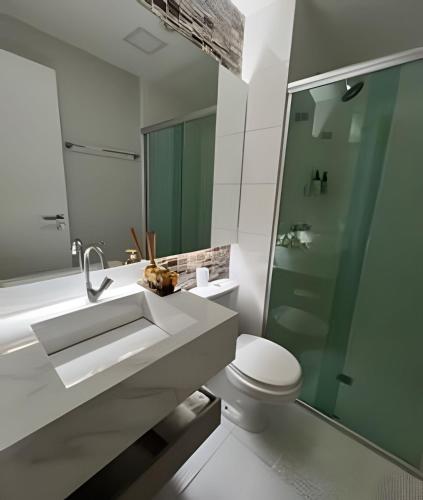 a bathroom with a sink and a toilet and a shower at Ed. Mandarim in Curro Velho