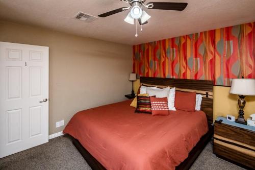 a bedroom with a bed and a ceiling fan at Desert Dreaming Pool Fire Pit Game Room in Lake Havasu City