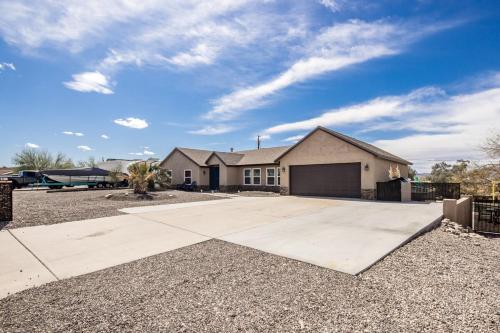 a house with a driveway in a yard at Desert Dreaming Pool Fire Pit Game Room in Lake Havasu City
