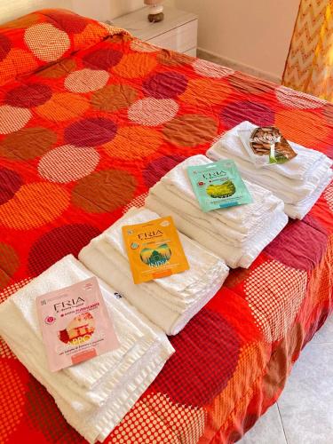 a bed with towels and books on top of it at Angolo di Sicilia in Partanna
