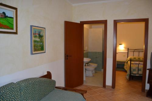 a room with a bathroom with a toilet and a sink at Agriturismo Fara del Falco in Vieste