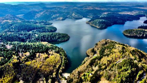 an aerial view of a lake in the mountains at Motel l'eau vive in Raon-lʼÉtape