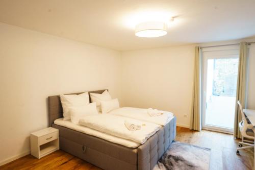 a small bedroom with a bed with a window at Prestige Apartments - Urban Lofts Reutlingen in Reutlingen
