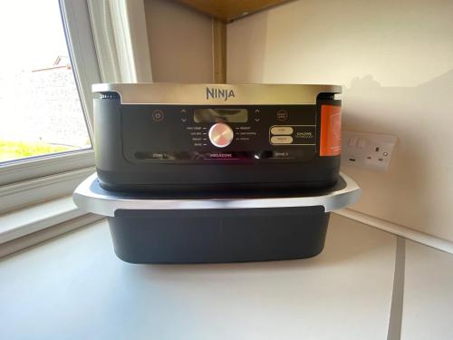 a toaster oven sitting on a counter next to a window at The Garden Room in Spittal