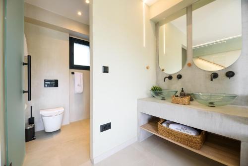 a bathroom with two sinks and a mirror at Topaz Suites in Pefkohori