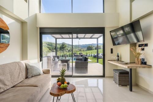 a living room with a couch and a table at Topaz Suites in Pefkohori