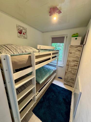 a room with two bunk beds and a window at Ferienhaus Haffschatz in Ueckermünde