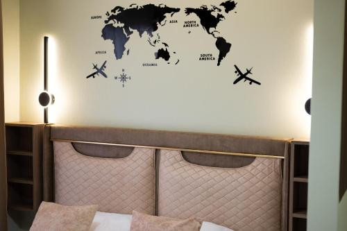 a bedroom with a bed with a map of the world at Hana Apartments in Ulcinj