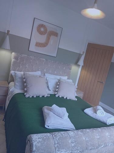 a bedroom with a large bed with white pillows at The Salt House in Amble