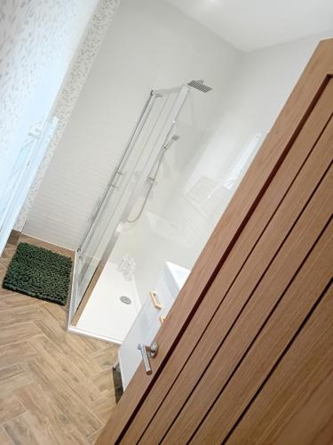 a glass door leading into a room with a floor at The Salt House in Amble