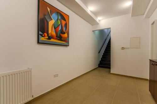 a hallway with a painting on the wall and a staircase at Kallisti Beach & Spa Villa - A Luxury Seaside Retreat in Lachi