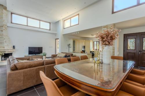 a living room with a table and a couch at Kallisti Beach & Spa Villa - A Luxury Seaside Retreat in Lachi