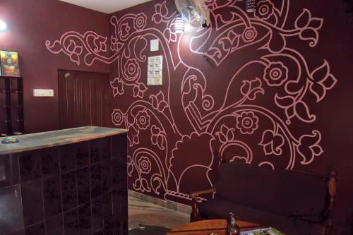 a wall with a wine bottle painted on it at Panchavadi Ayurvedic Beach Resort in Varkala