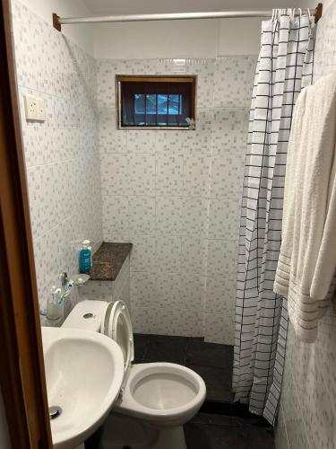 a bathroom with a sink and a toilet and a window at Colombo Green Heaven in Cotta Road Railroad Station