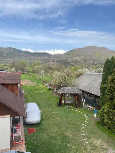 an aerial view of a farm with a house and a field at Pension Bud in Onceşti