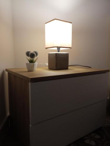 a table with a lamp on top of a dresser at YOUR HOME 26 in Bari
