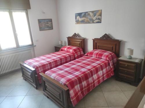 a bedroom with two beds and two night stands at La Mergozzina in Mergozzo
