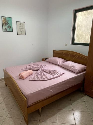 a bed with pink sheets and pink pillows on it at Sea flavor in Shëngjin