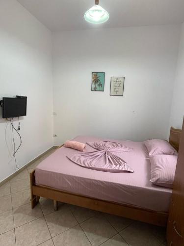 a bedroom with a bed with a purple blanket at Sea flavor in Shëngjin