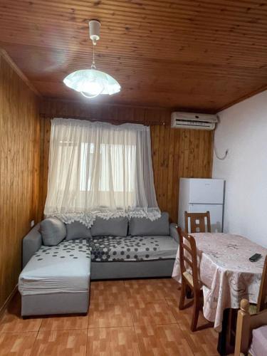 a living room with a couch and a table at Sea flavor in Shëngjin