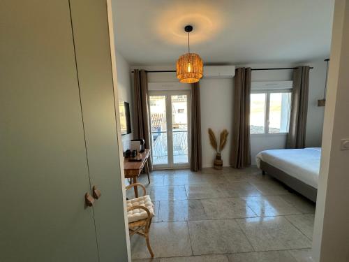 a bedroom with a bed and a table and a lamp at 27 côté remparts in Aigues-Mortes