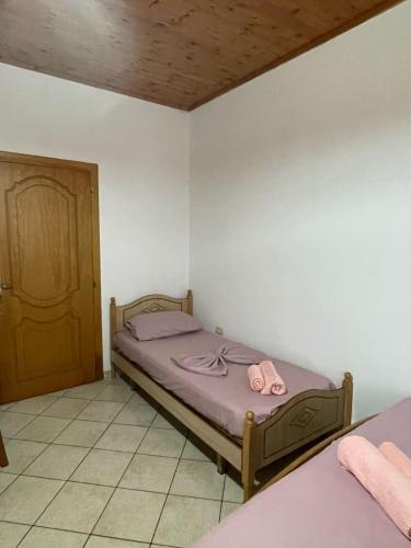 a bedroom with a bed with two pink towels on it at Sea flavor in Shëngjin