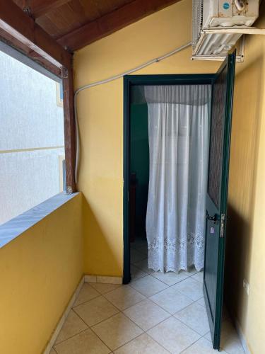 a door to a room with a white curtain at Sea flavor in Shëngjin