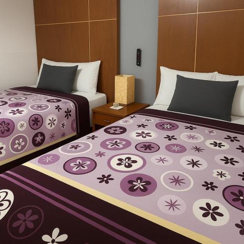 two beds sitting next to each other in a room at Hotel Galeria & Boutique in Mexico City