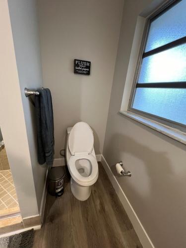 a bathroom with a toilet and a sign on the wall at Venice Florida near beach in Venice