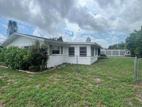a white house with a yard in front of it at Venice Florida near beach in Venice